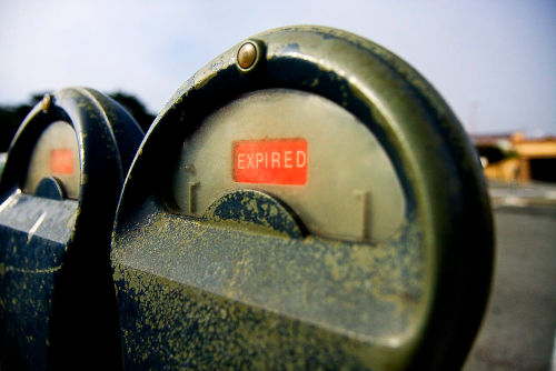 An old-fashioned parking meter with the expired flag showing.